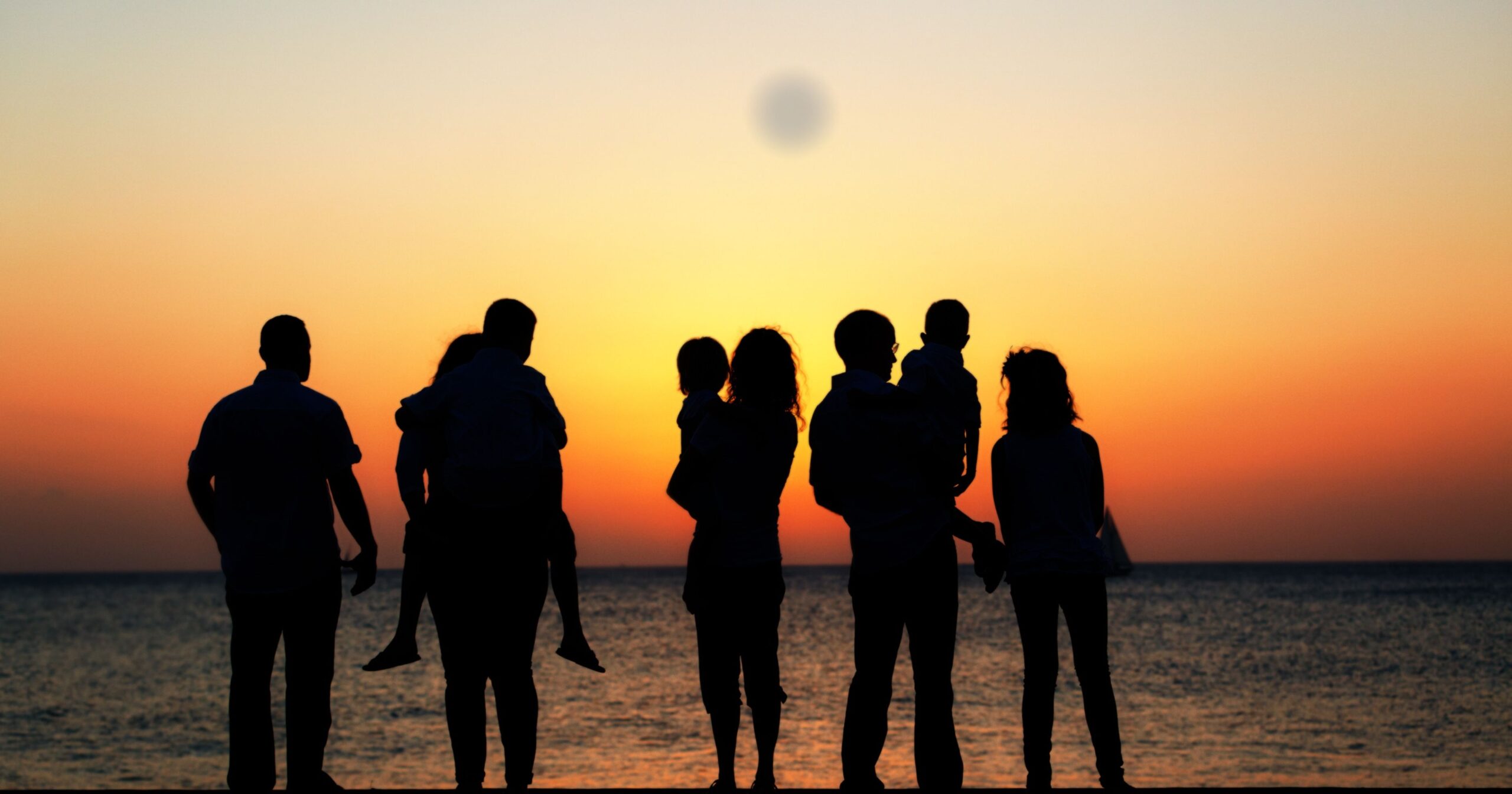Family all together on beach at sunset